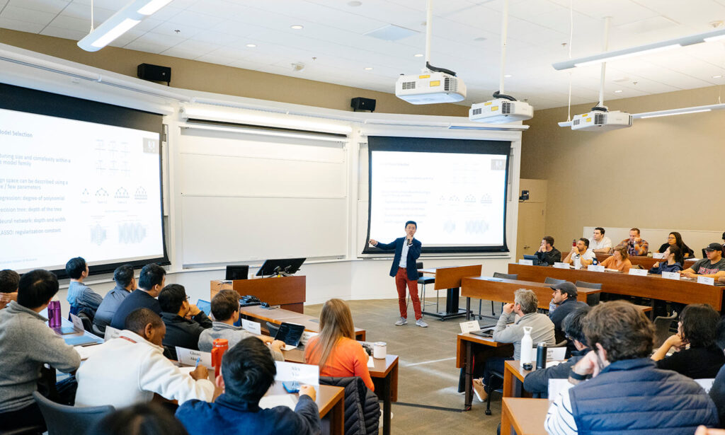 Photo of Kuang Xu lecturing to a modern-day class